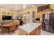 Bright kitchen with a center island, stainless steel refrigerator and casual dining area at 115 E Spur Ave, Gilbert, AZ 85296