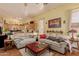 Bright living room with comfortable sofas, wood flooring, and decorative niches adding character and charm at 115 E Spur Ave, Gilbert, AZ 85296
