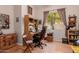 Comfortable home office featuring a desk, natural light, classic furnishings, and laminate flooring at 115 E Spur Ave, Gilbert, AZ 85296