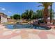 The pool features a rock waterfall, perfect for relaxation and adding natural beauty to the backyard at 115 E Spur Ave, Gilbert, AZ 85296
