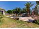 A backyard pool area features a waterfall, desert landscaping, and lush greenery for a relaxing outdoor oasis at 115 E Spur Ave, Gilbert, AZ 85296