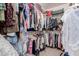 Organized walk-in closet providing ample storage with shelves and hanging racks for clothes, shoes and personal items at 115 E Spur Ave, Gilbert, AZ 85296