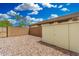 Desert landscaped backyard featuring block fence, storage shed, and a secure gated access point at 12023 W Duane Ln, Peoria, AZ 85383