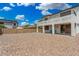 Expansive backyard featuring a covered patio, second-story balcony, and low-maintenance desert landscaping at 12023 W Duane Ln, Peoria, AZ 85383