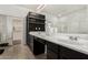Primary bathroom with double sinks, ample counter space, open closet, and glass enclosed shower at 12023 W Duane Ln, Peoria, AZ 85383