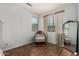 Bright bedroom with wood floors, a neutral chair, a large window, and decorative curtains at 12023 W Duane Ln, Peoria, AZ 85383