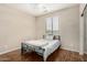 Cozy bedroom featuring hardwood floors, large window, and a comfy bed at 12023 W Duane Ln, Peoria, AZ 85383