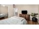 Bedroom featuring hardwood floors, dresser, large window, and cozy bed at 12023 W Duane Ln, Peoria, AZ 85383