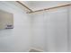 A simple walk-in closet with a clothes rod and some shelving for home organization at 12023 W Duane Ln, Peoria, AZ 85383