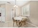 Cozy dining area features a modern chandelier, plantation shutters, and a breakfast table at 12023 W Duane Ln, Peoria, AZ 85383
