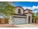 Two-story white home featuring a tile roof and a two-car garage at 12023 W Duane Ln, Peoria, AZ 85383