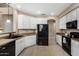 Spacious kitchen features modern appliances, white cabinets, and granite countertops, offering ample space to prepare food at 12023 W Duane Ln, Peoria, AZ 85383