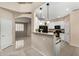 Open kitchen boasts white cabinets, granite countertops, and seamless access to the dining and living areas at 12023 W Duane Ln, Peoria, AZ 85383