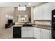 The kitchen features granite countertops, white cabinets, and modern appliances, offering a sleek cooking space at 12023 W Duane Ln, Peoria, AZ 85383