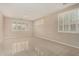 A well-lit living room with large windows, shutters, and tile flooring at 12023 W Duane Ln, Peoria, AZ 85383