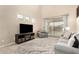 Comfortable living room with modern decor, high ceilings, and a sliding glass door to the patio at 12023 W Duane Ln, Peoria, AZ 85383