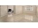 Open-concept living room with tile floors and an abundance of natural light at 12023 W Duane Ln, Peoria, AZ 85383