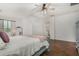 Spacious main bedroom with hardwood floors, ceiling fan, ensuite bathroom, and sunny windows at 12023 W Duane Ln, Peoria, AZ 85383