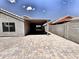 Spacious backyard features a covered patio and low-maintenance landscaping with paver stones at 1339 W Mesquite Ave, Apache Junction, AZ 85120