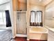 Bright bathroom features a standalone shower, soaking tub, and wood look flooring at 1339 W Mesquite Ave, Apache Junction, AZ 85120