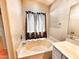 Well-lit bathroom features a soaking tub with modern fixtures and a stylish vanity at 1339 W Mesquite Ave, Apache Junction, AZ 85120