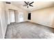 Spacious bedroom features neutral carpet, a ceiling fan, and a bright window at 1339 W Mesquite Ave, Apache Junction, AZ 85120