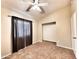 Neutral bedroom with carpet flooring features a ceiling fan and ample natural light at 1339 W Mesquite Ave, Apache Junction, AZ 85120