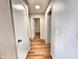Hallway featuring wood-look floors, white trim, and access to multiple rooms at 1339 W Mesquite Ave, Apache Junction, AZ 85120