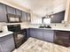 Open kitchen featuring black appliances, dark gray cabinets, tile floor, and bright white countertops at 1339 W Mesquite Ave, Apache Junction, AZ 85120