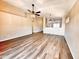 Open-concept living room with wood floors, a ceiling fan, and a view into the adjacent kitchen at 1339 W Mesquite Ave, Apache Junction, AZ 85120