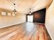 Spacious living room featuring wood floors, ceiling fans, recessed lighting and a modern dark accent wall at 1339 W Mesquite Ave, Apache Junction, AZ 85120