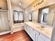 Bright main bathroom featuring double sinks, a bathtub, and a glass-enclosed shower at 1339 W Mesquite Ave, Apache Junction, AZ 85120