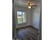 Bedroom featuring wood floors, neutral walls, and an exterior view through the window at 13801 N 37Th Dr, Phoenix, AZ 85053