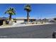 Charming single-story home featuring mature palm trees and a well-maintained front yard at 13801 N 37Th Dr, Phoenix, AZ 85053
