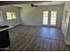 Bright, airy living room with contemporary wood floors and natural light from the French doors at 13801 N 37Th Dr, Phoenix, AZ 85053