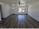 Bright living room featuring wood-look flooring, fresh white paint, and a modern ceiling fan at 13801 N 37Th Dr, Phoenix, AZ 85053