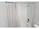 Clean, tiled shower with shower curtain at 13801 N 37Th Dr, Phoenix, AZ 85053