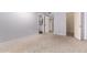 Carpeted bedroom with an ensuite bathroom and walk-in closet at 14224 N Newcastle Dr, Sun City, AZ 85351