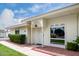 Inviting single-story home with a tidy walkway leading to a secure, gated entrance at 14224 N Newcastle Dr, Sun City, AZ 85351
