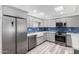 Modern kitchen featuring stainless steel appliances and stylish blue backsplash at 14224 N Newcastle Dr, Sun City, AZ 85351