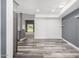 Open-concept living room boasts wood grain flooring, grey accent wall, and natural light at 14224 N Newcastle Dr, Sun City, AZ 85351