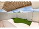 Private outdoor patio with artificial turf and a covered seating area at 14224 N Newcastle Dr, Sun City, AZ 85351