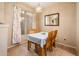 Cozy dining room features natural light from the large window, a decorative mirror, and a table set for a meal at 14950 W Mountain View Blvd # 5306, Surprise, AZ 85374