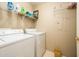 Functional laundry room with a washing machine, dryer, and plenty of shelf space for storage at 14950 W Mountain View Blvd # 5306, Surprise, AZ 85374