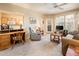 Open living area with comfortable seating, a work desk, and views into the kitchen at 14950 W Mountain View Blvd # 5306, Surprise, AZ 85374