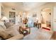 Inviting living area with comfortable seating and views into the dining room and kitchen at 14950 W Mountain View Blvd # 5306, Surprise, AZ 85374