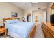 Relaxing main bedroom with a view to the bathroom, a ceiling fan, and ample closet space at 14950 W Mountain View Blvd # 5306, Surprise, AZ 85374