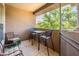 Relaxing patio area with comfortable seating and a view of the surrounding trees, perfect for outdoor enjoyment at 14950 W Mountain View Blvd # 5306, Surprise, AZ 85374