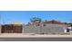 Exterior view of a home with block wall, wood fence, desert landscaping, and low-maintenance backyard at 1586 S Lawther Dr, Apache Junction, AZ 85120