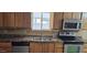 A kitchen with stainless steel appliances, wooden cabinets and drawers, and natural light at 1586 S Lawther Dr, Apache Junction, AZ 85120